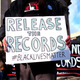 Protesters display a banner and placards during a demonstration outside the courthouse in the New York City borough of Staten Island Jan. 5, 2015, before a hearing in a state lawsuit seeking the release of grand jury proceedings concerning the death of Eric Garner.
JEWEL SAMAD/Getty Images